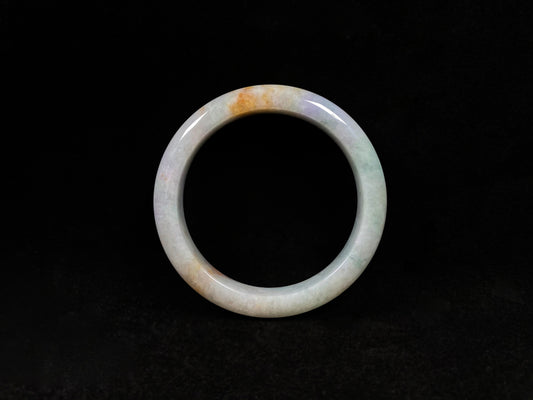 This tricolor jadeite bangle combines yellow, purple, and green, symbolizing fortune, prosperity, and longevity.