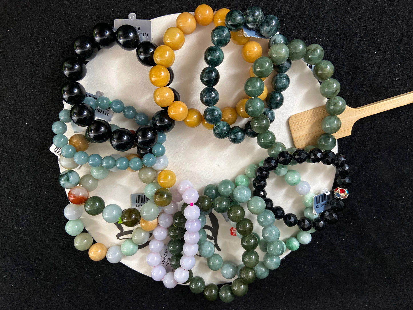 A collection of 12 jade bead strands in varied colors.