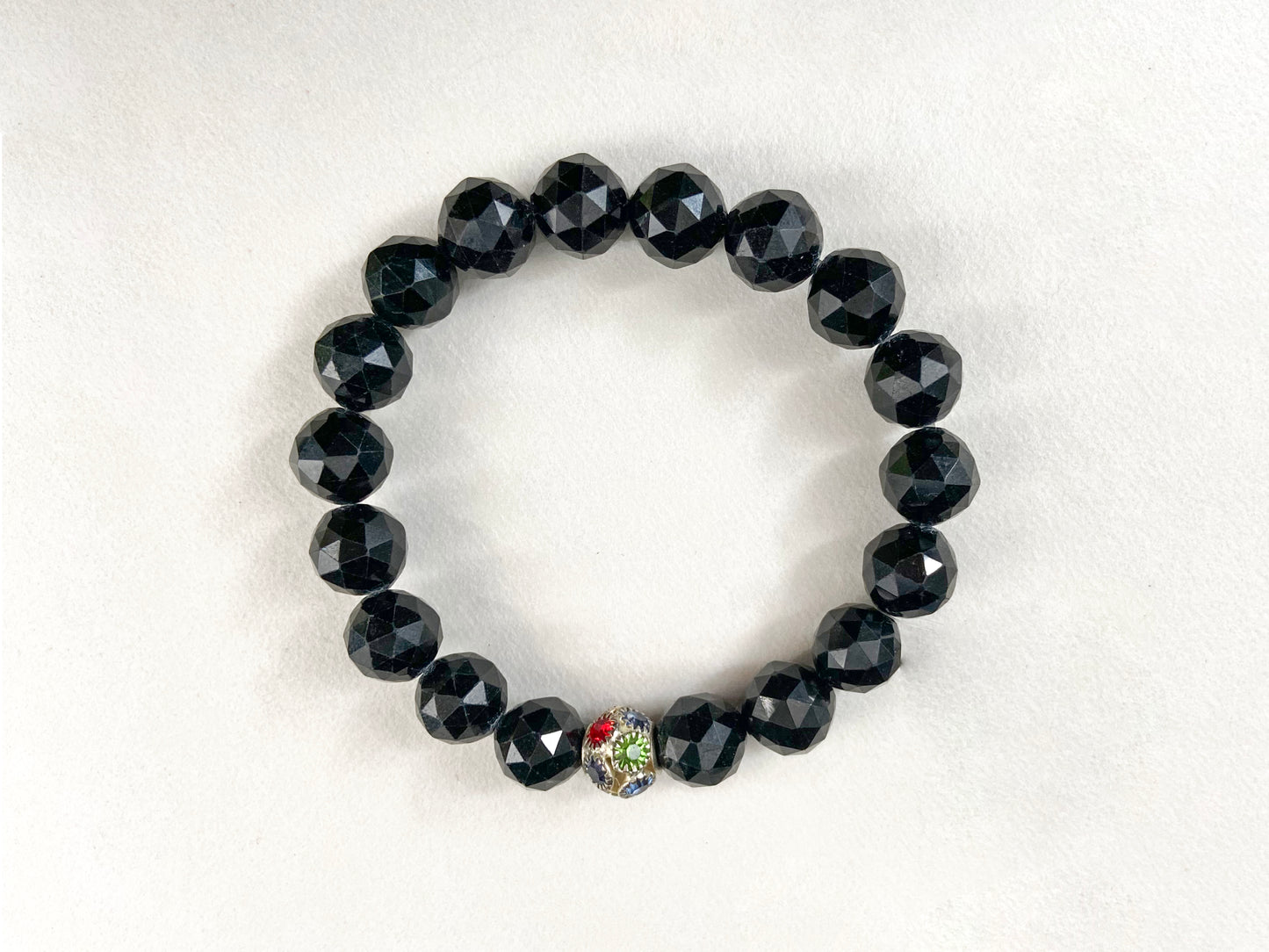 This jadeite bead strand has 18 black faceted beads, accented with alloy beads.