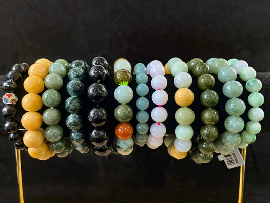 A collection of 12 jade bead strands in varied colors.