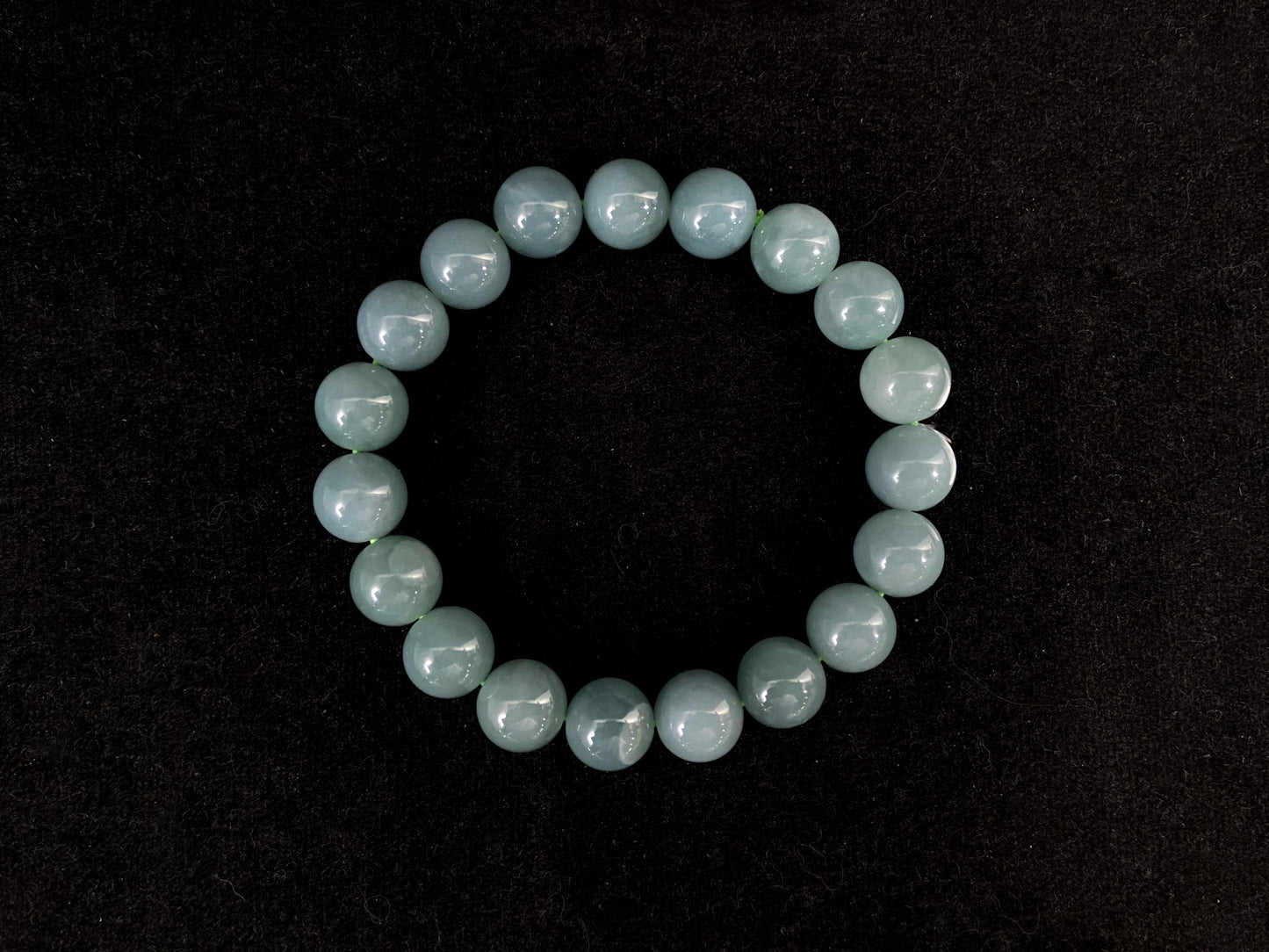 This jadeite strand consists of consistent sized gray blue beads.