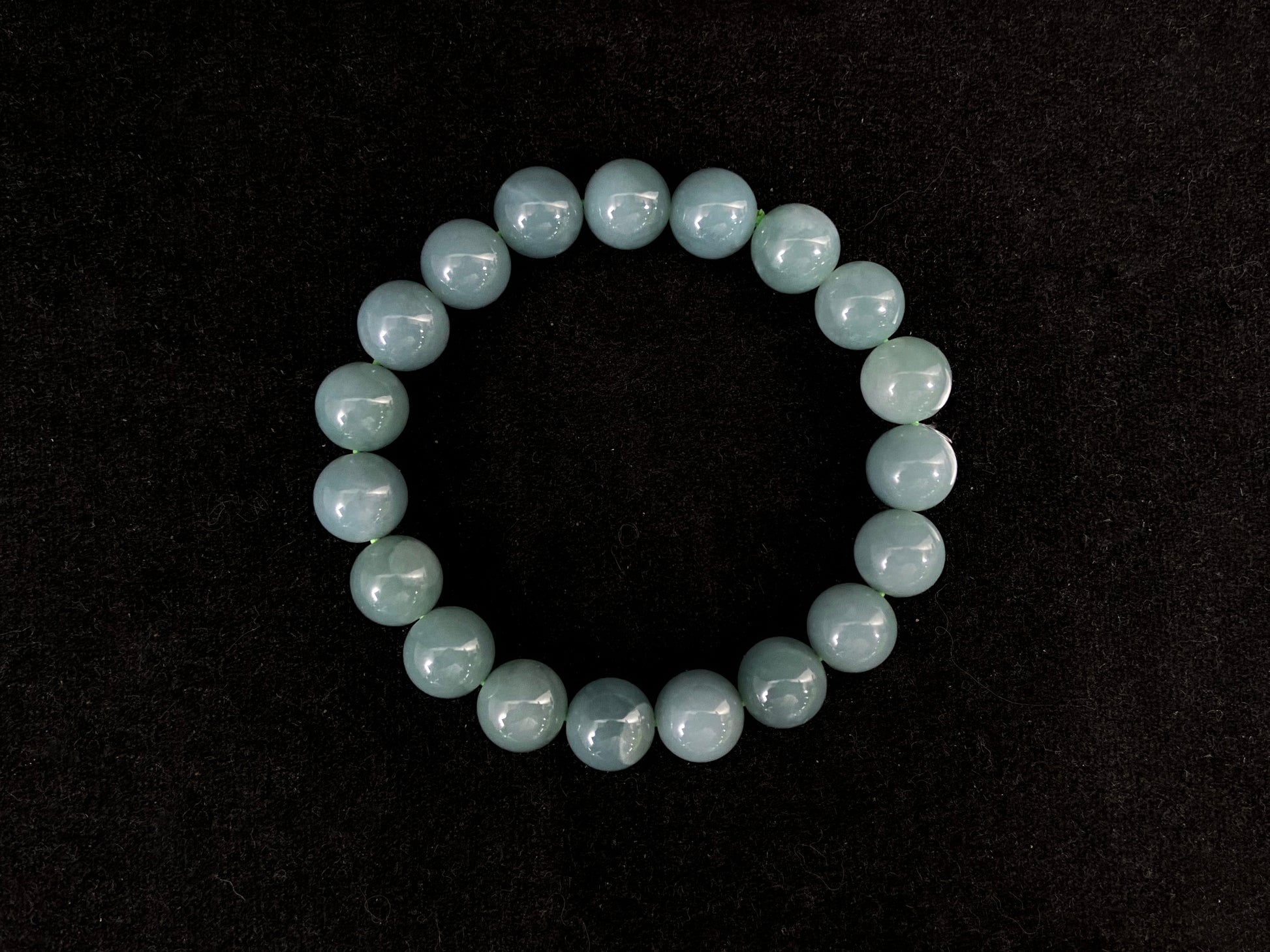 This jadeite strand consists of consistent sized gray blue beads.