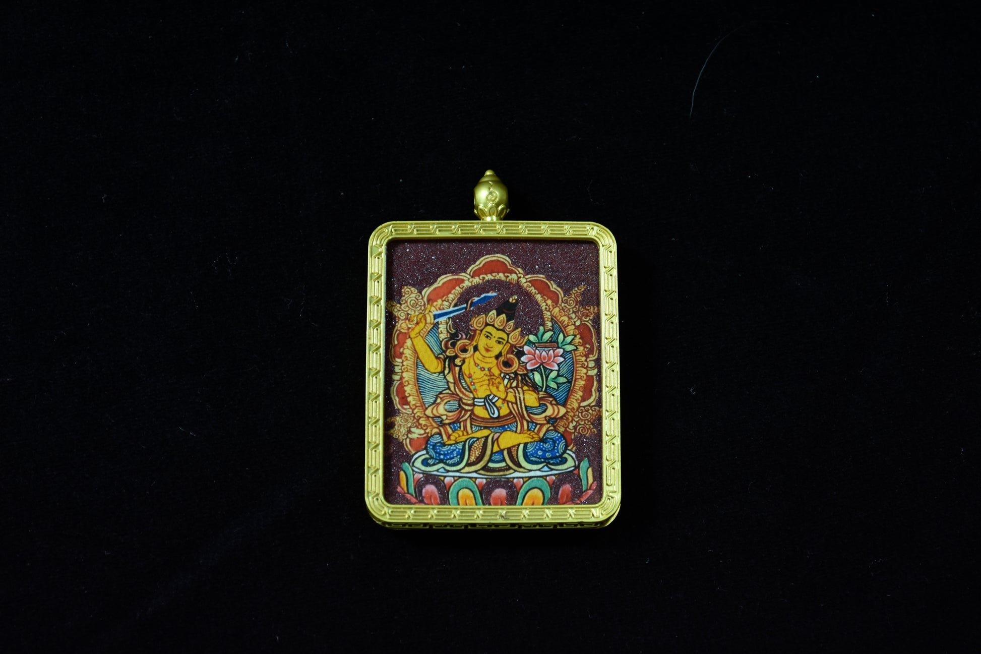 Decorative pendant with a colorful design on a black background