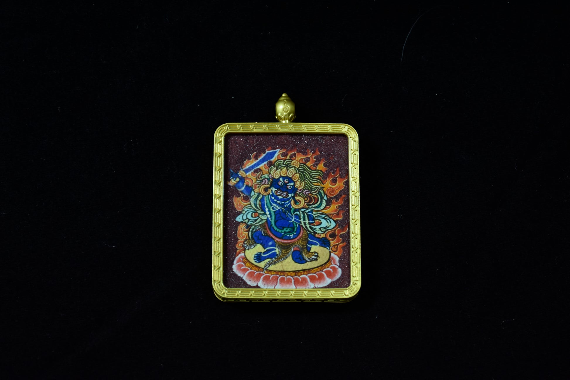 Decorative pendant with a colorful design on a black background