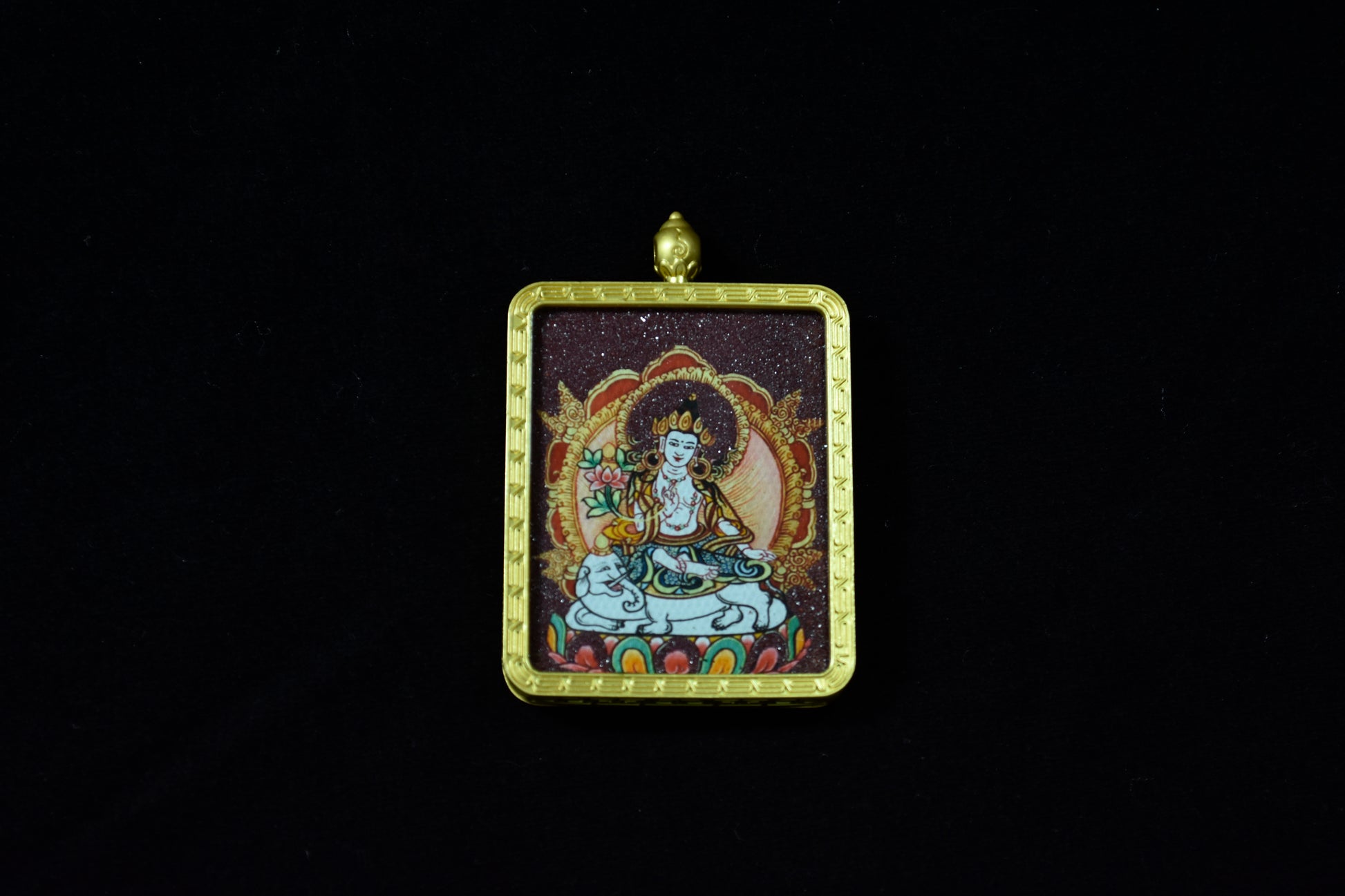 Pendant with a religious figure in a gold frame on a black background