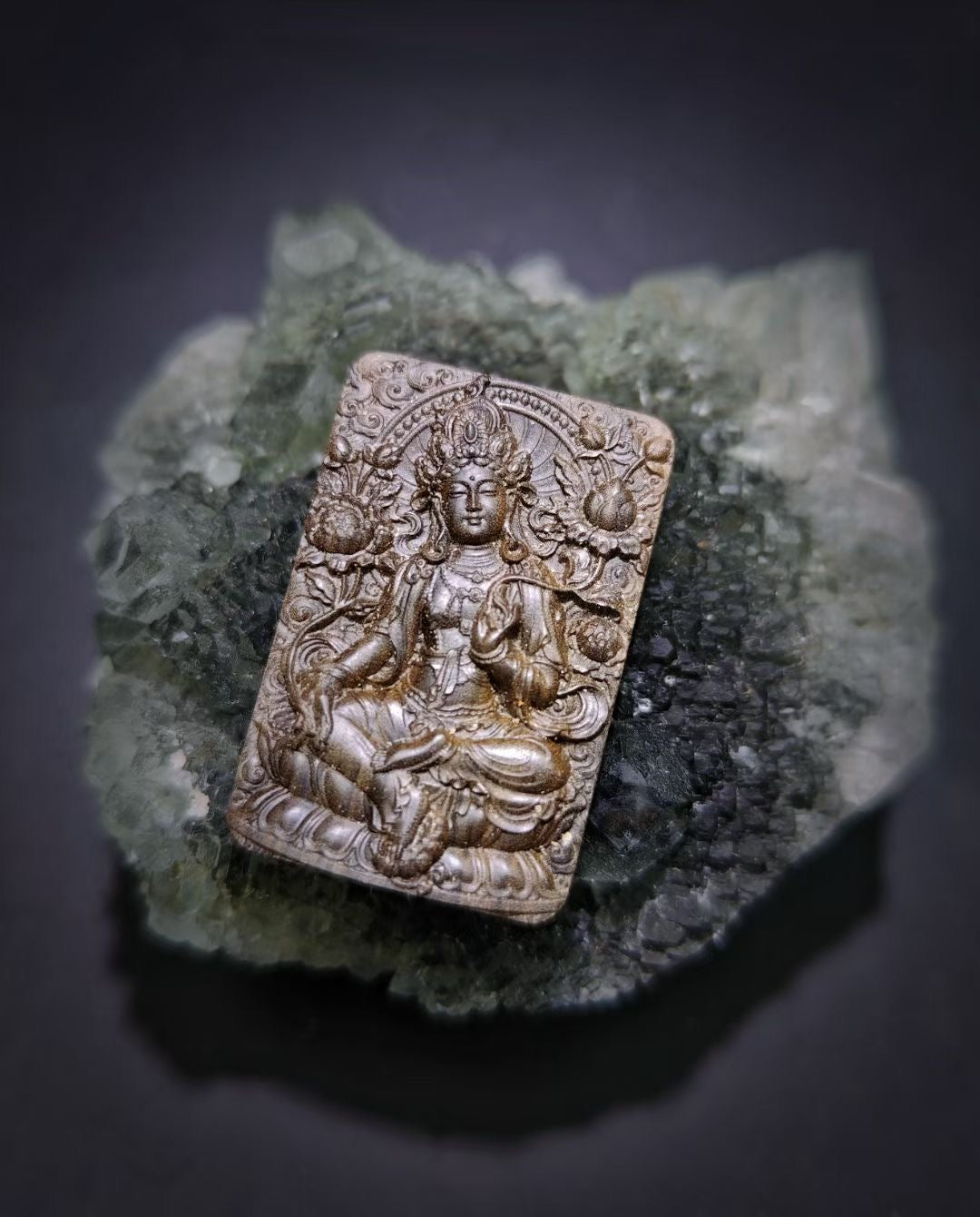 Decorative stone plaque with a figure on a dark background