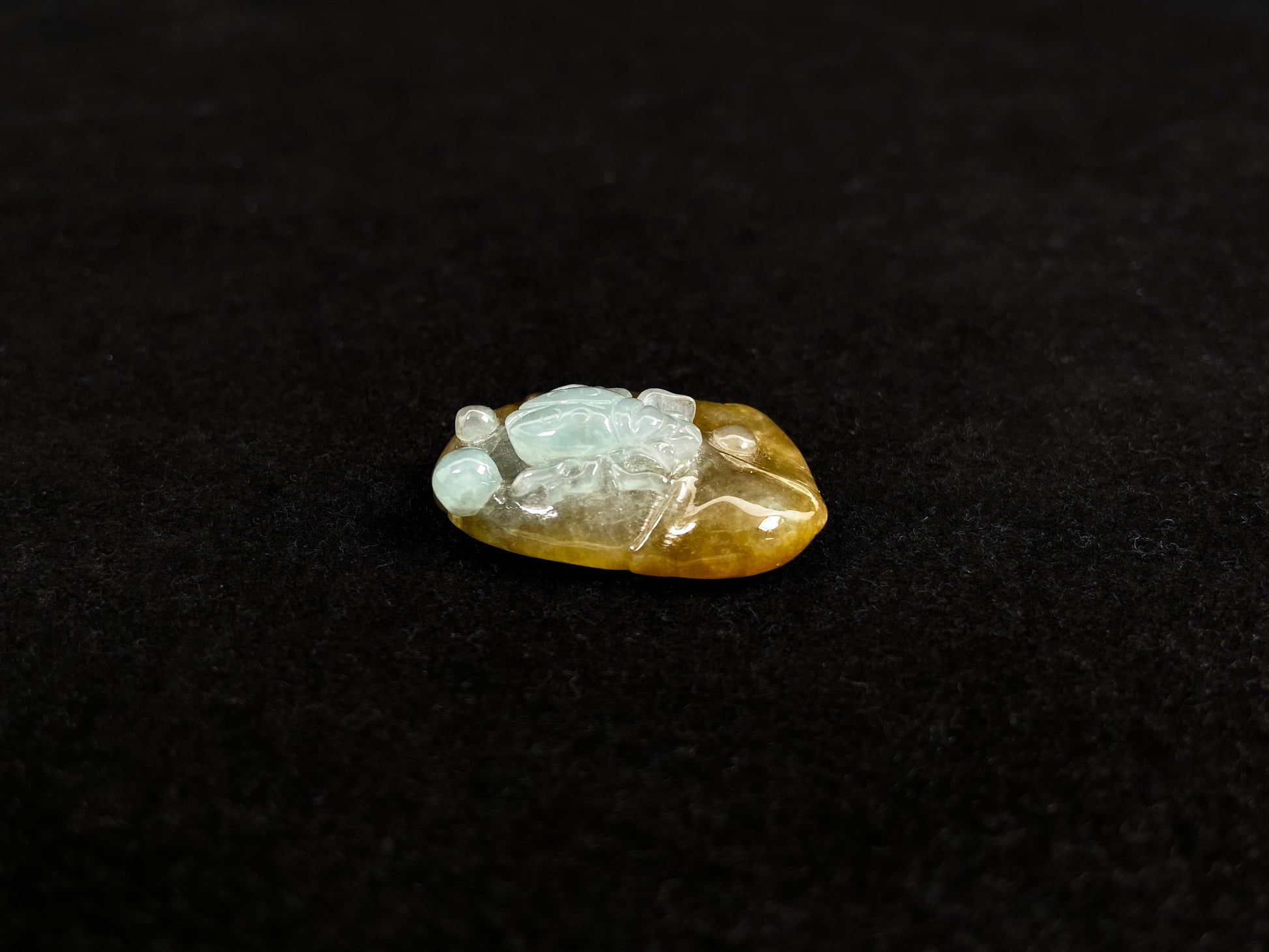 This yellow jadeite features a crawling spider in milky white translucent jadeite.