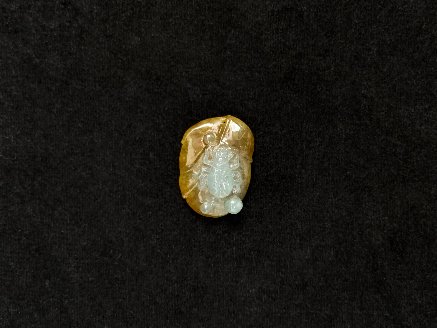 This yellow jadeite features a crawling spider in milky white translucent jadeite.