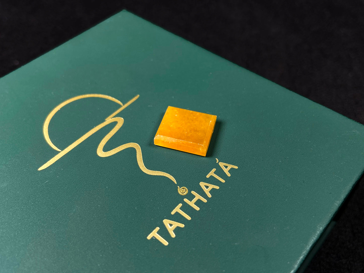 A warm yellow jadeite cut into a charming sugar cube shape.