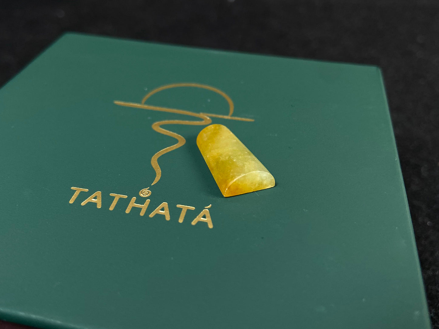 This honey colored jade features a half round shape.