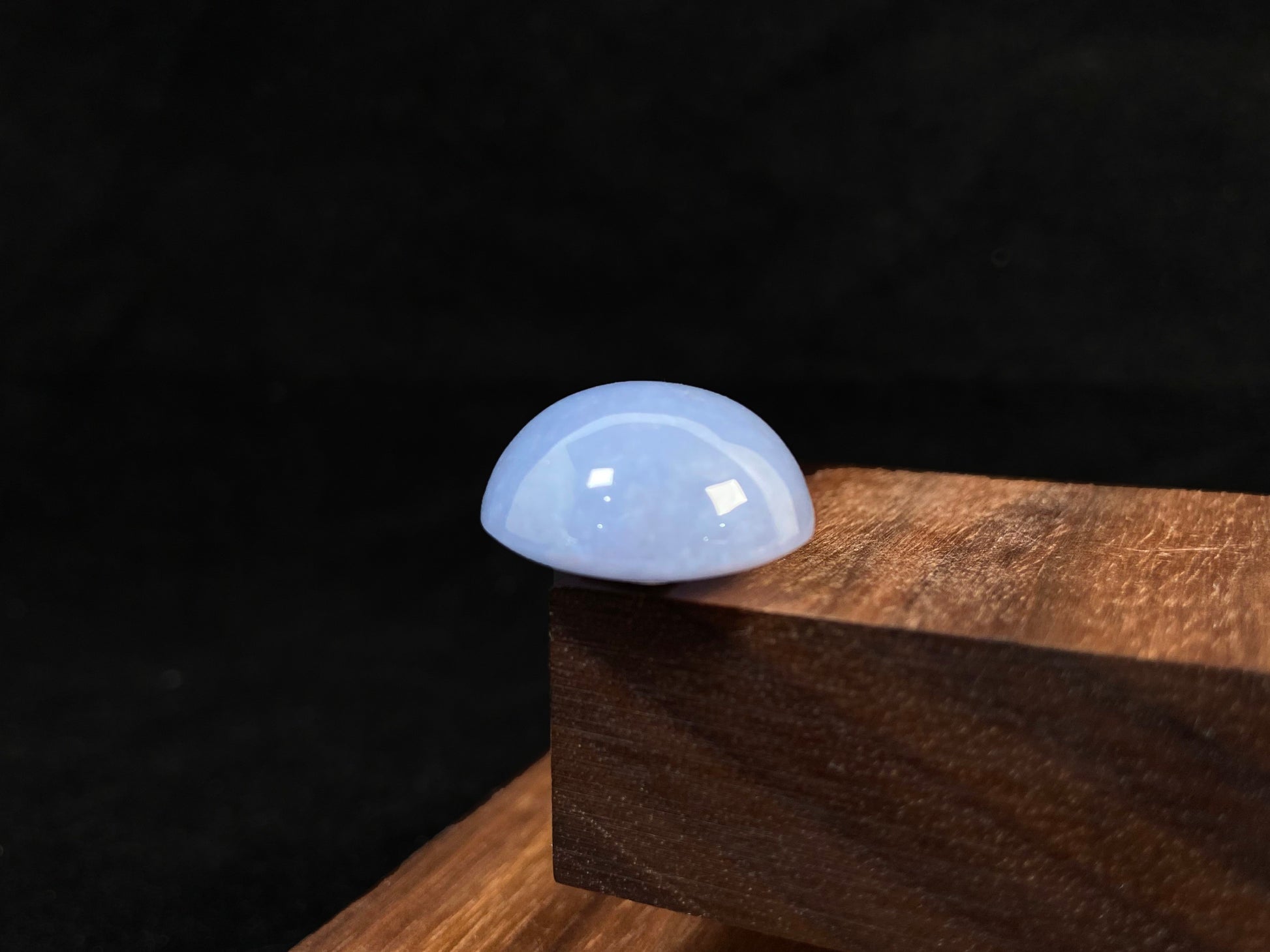 Purple jade in a perfect semi circle cut.