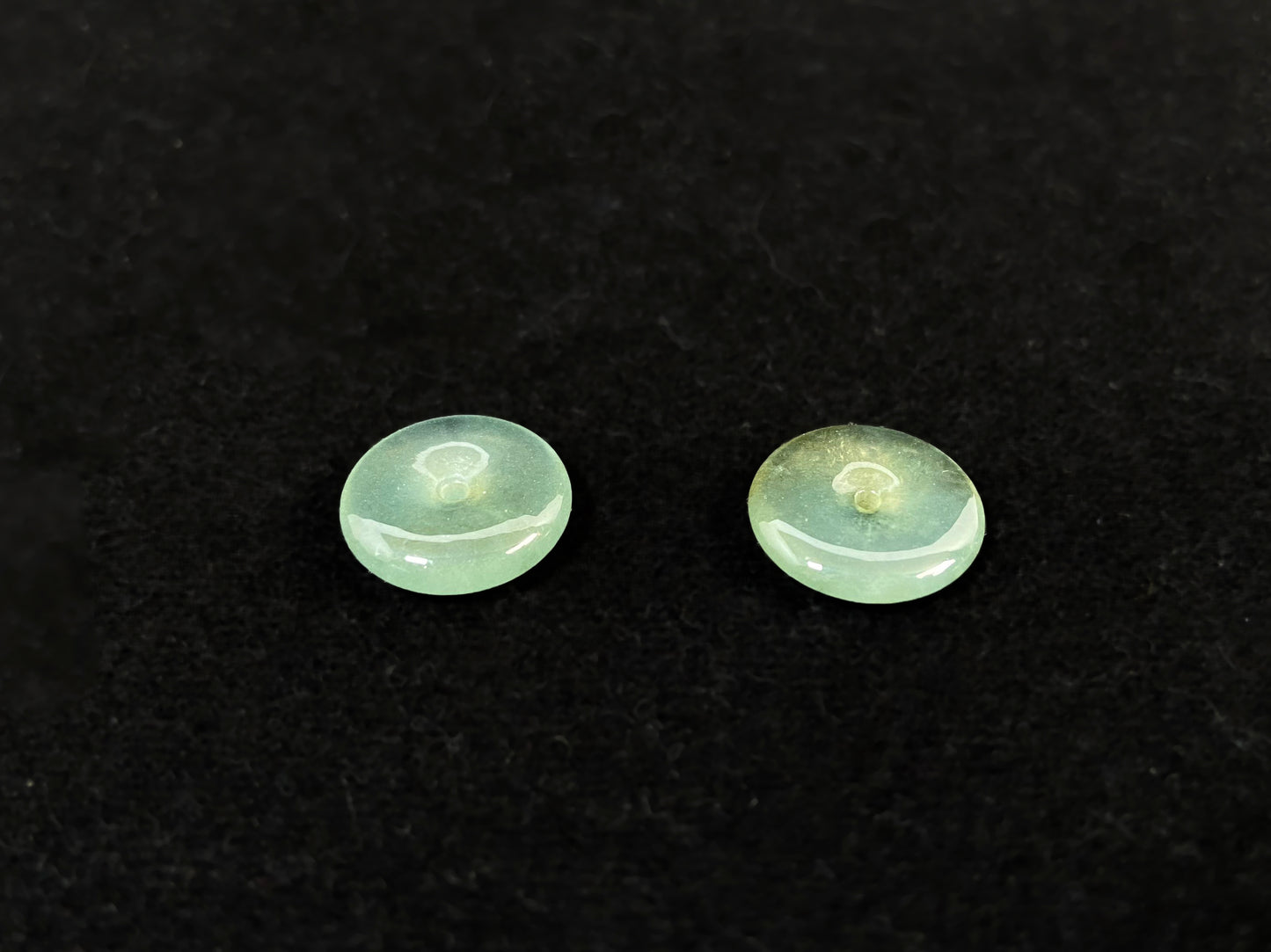 Two transparent mint green jade rounds with gold dusting.
