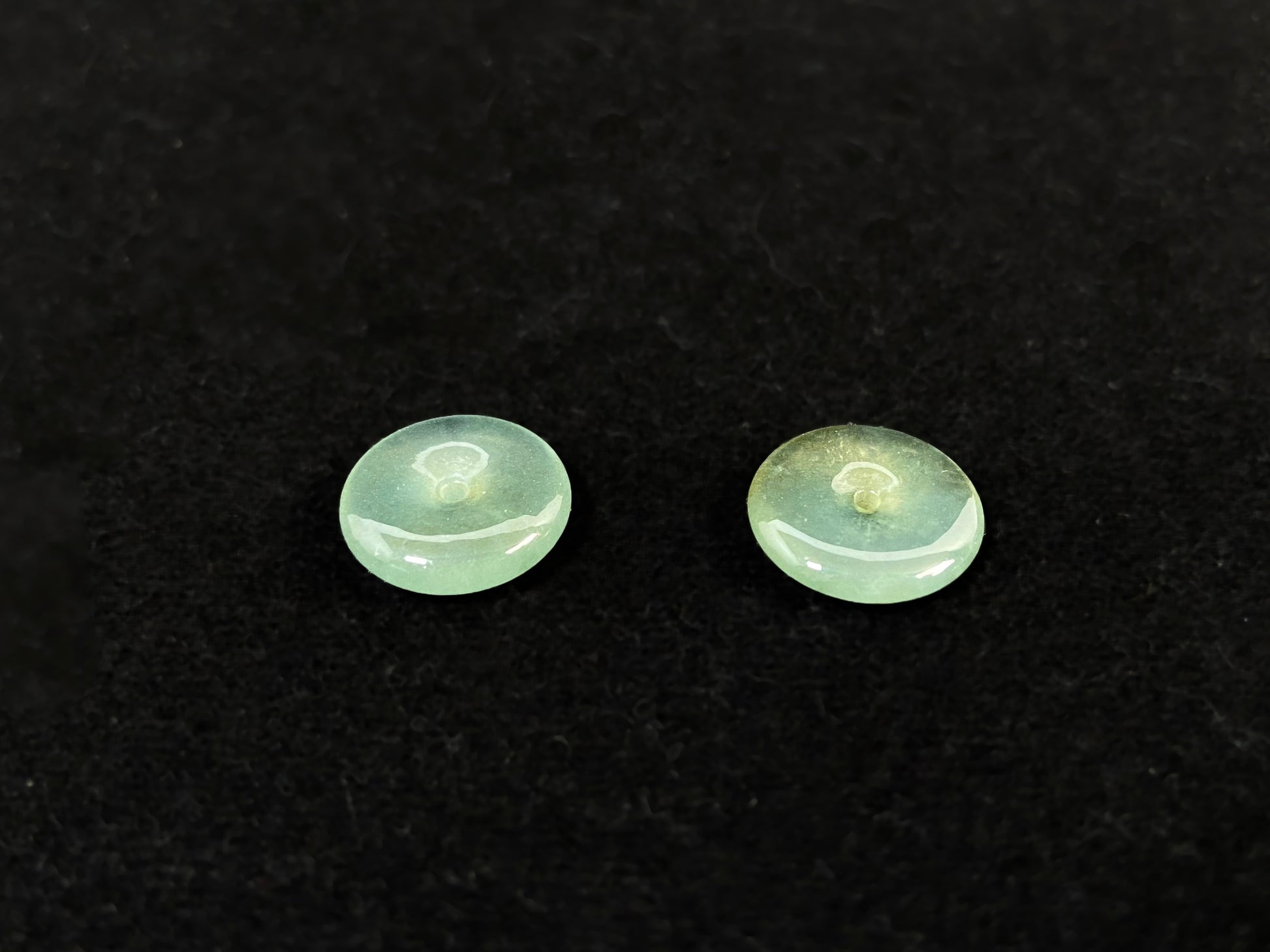 Two transparent mint green jade rounds with gold dusting.