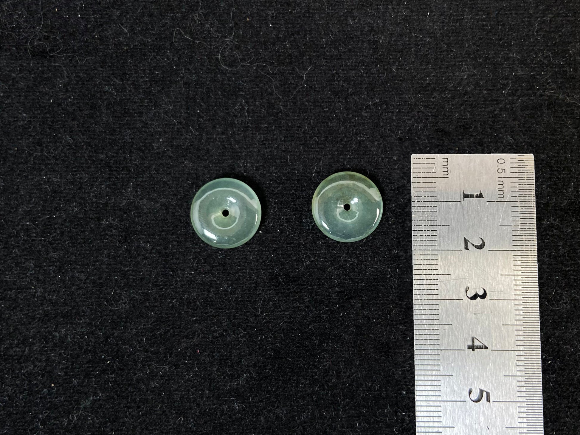 Two transparent mint green jade rounds with gold dusting.
