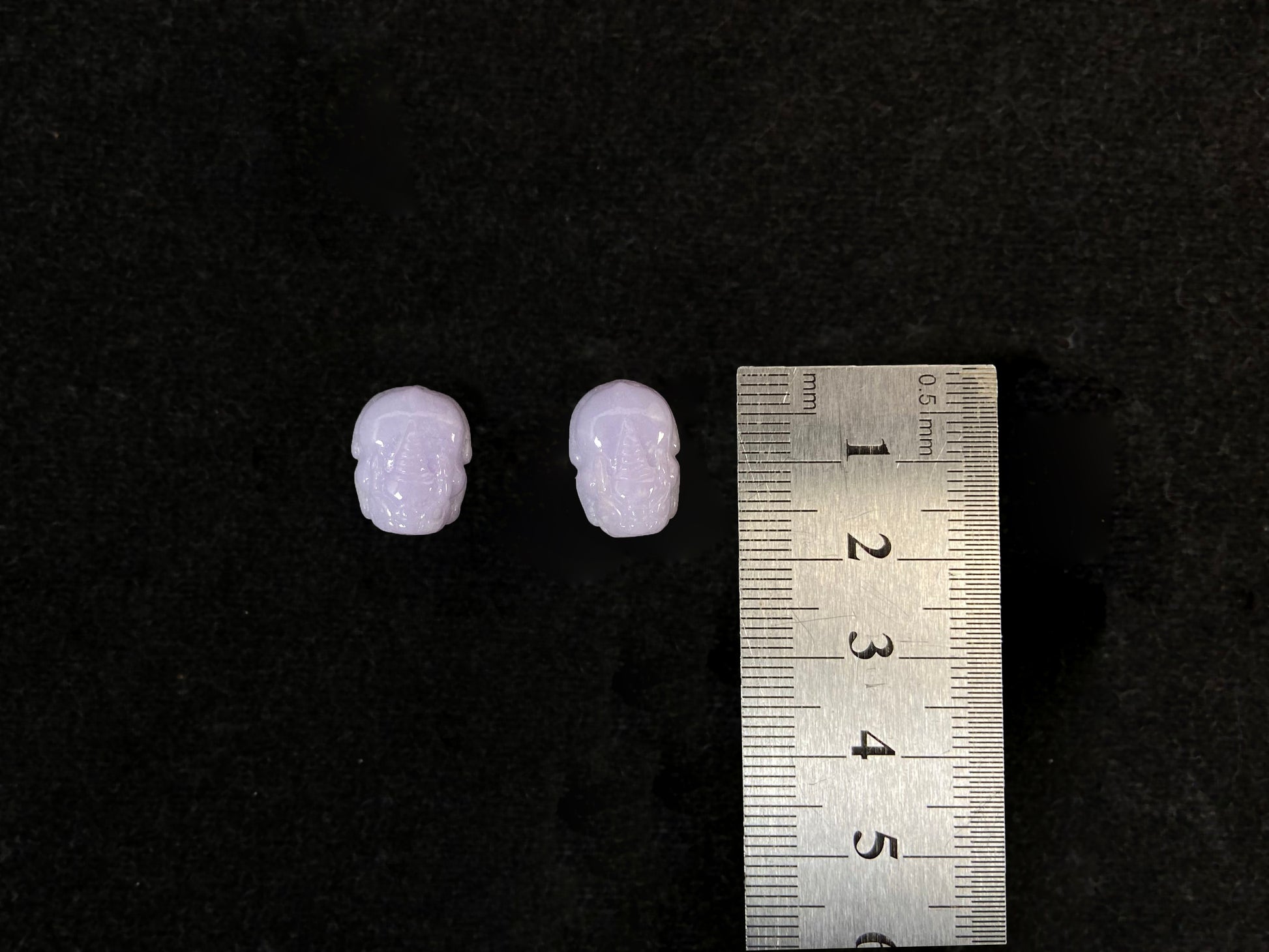 A set of two purple jade Pi Xiu figures: one plump and one slender.