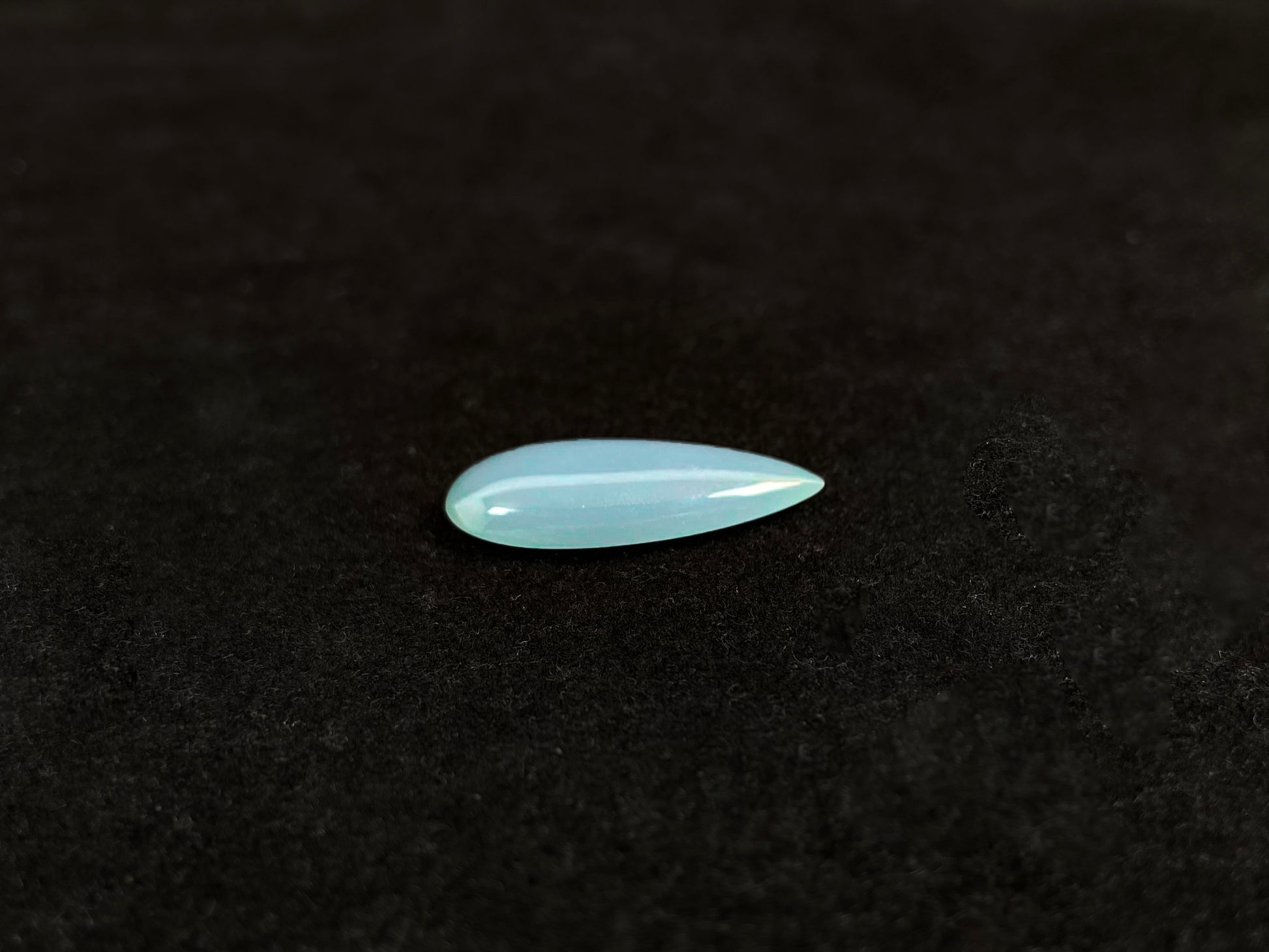 A blue, semi-transparent teardrop jadeite.
