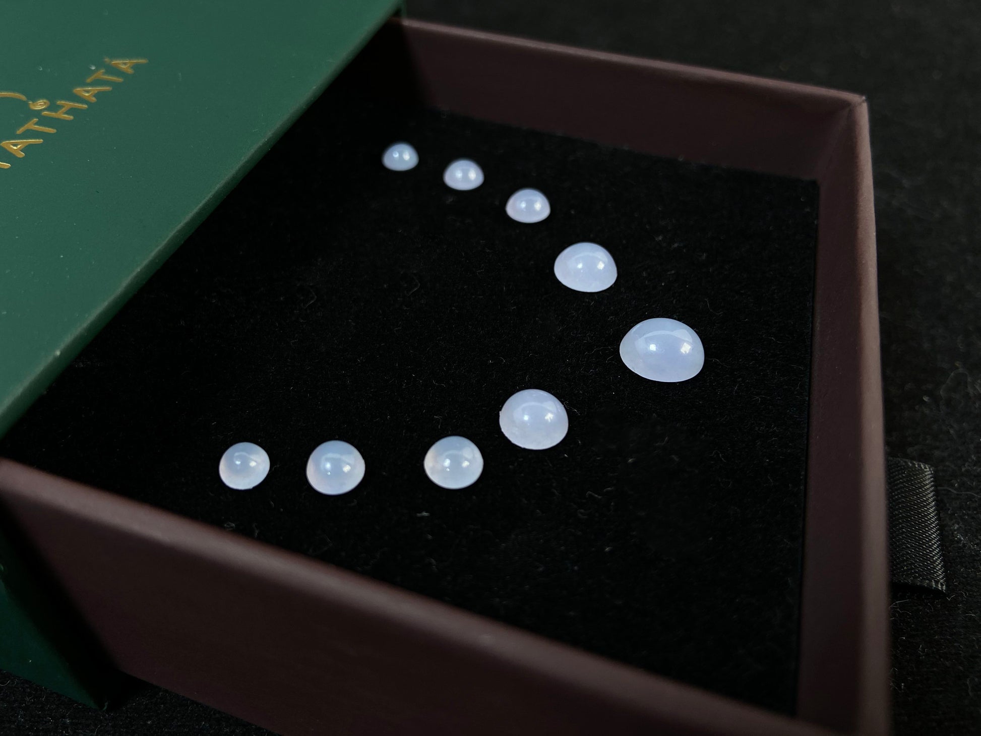 A lavender dewdrop nine stone set loose jadeite.