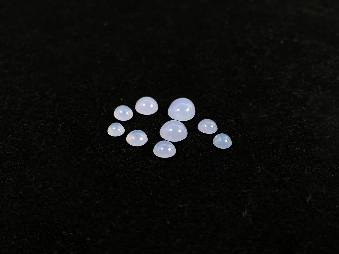 A lavender dewdrop nine stone set loose jadeite.