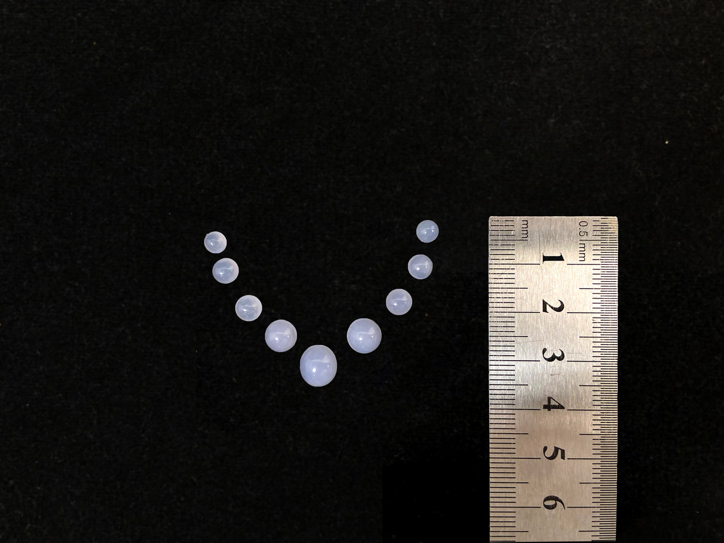 A lavender dewdrop nine stone set loose jadeite.