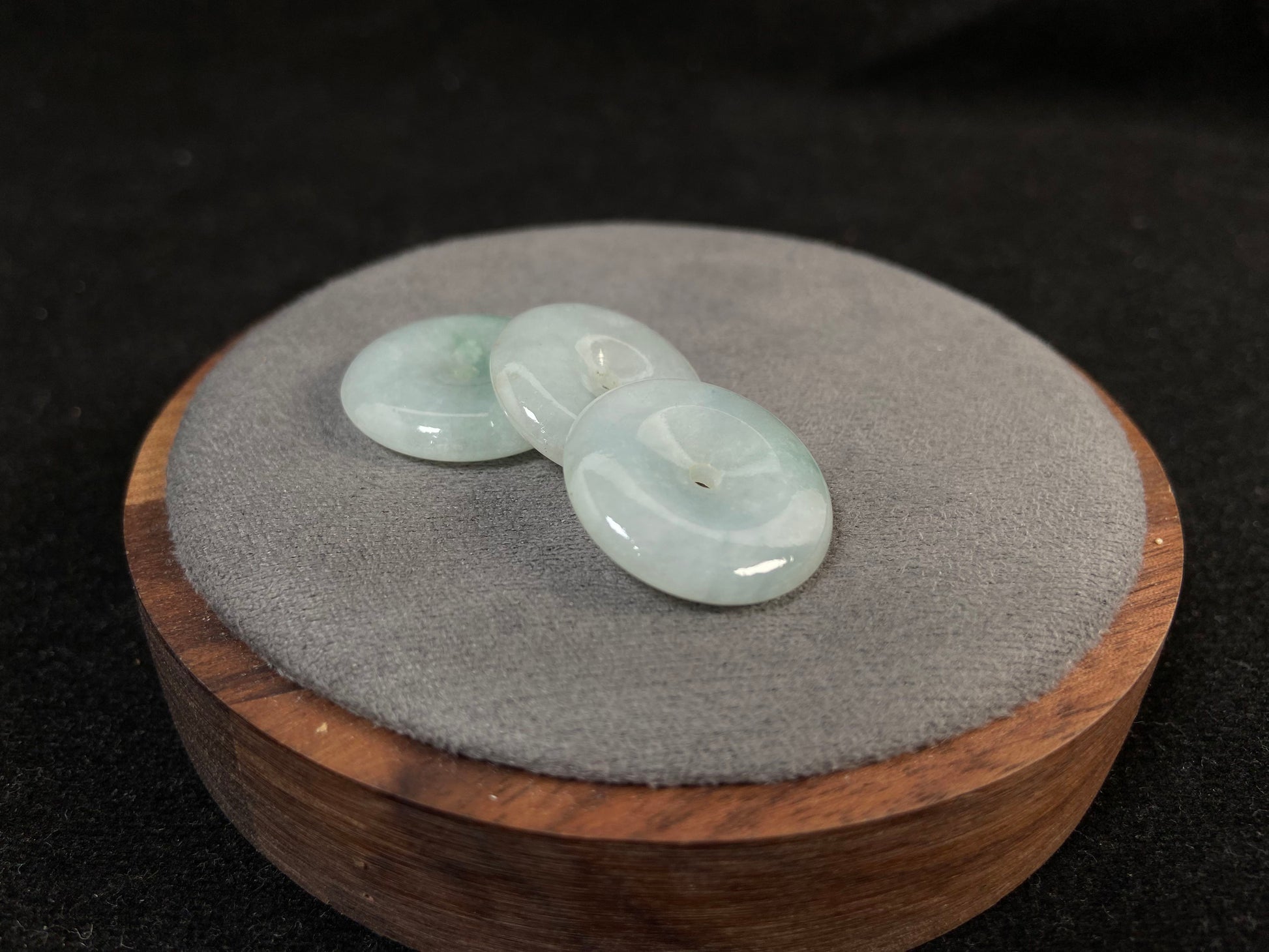 Translucent white jade cabochons featuring soft green patterns.