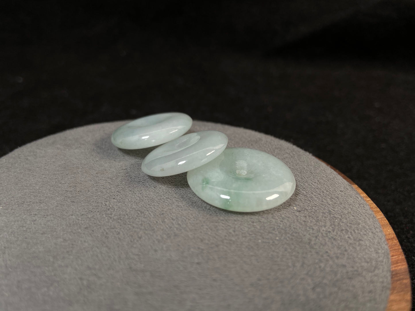 Translucent white jade cabochons featuring soft green patterns.