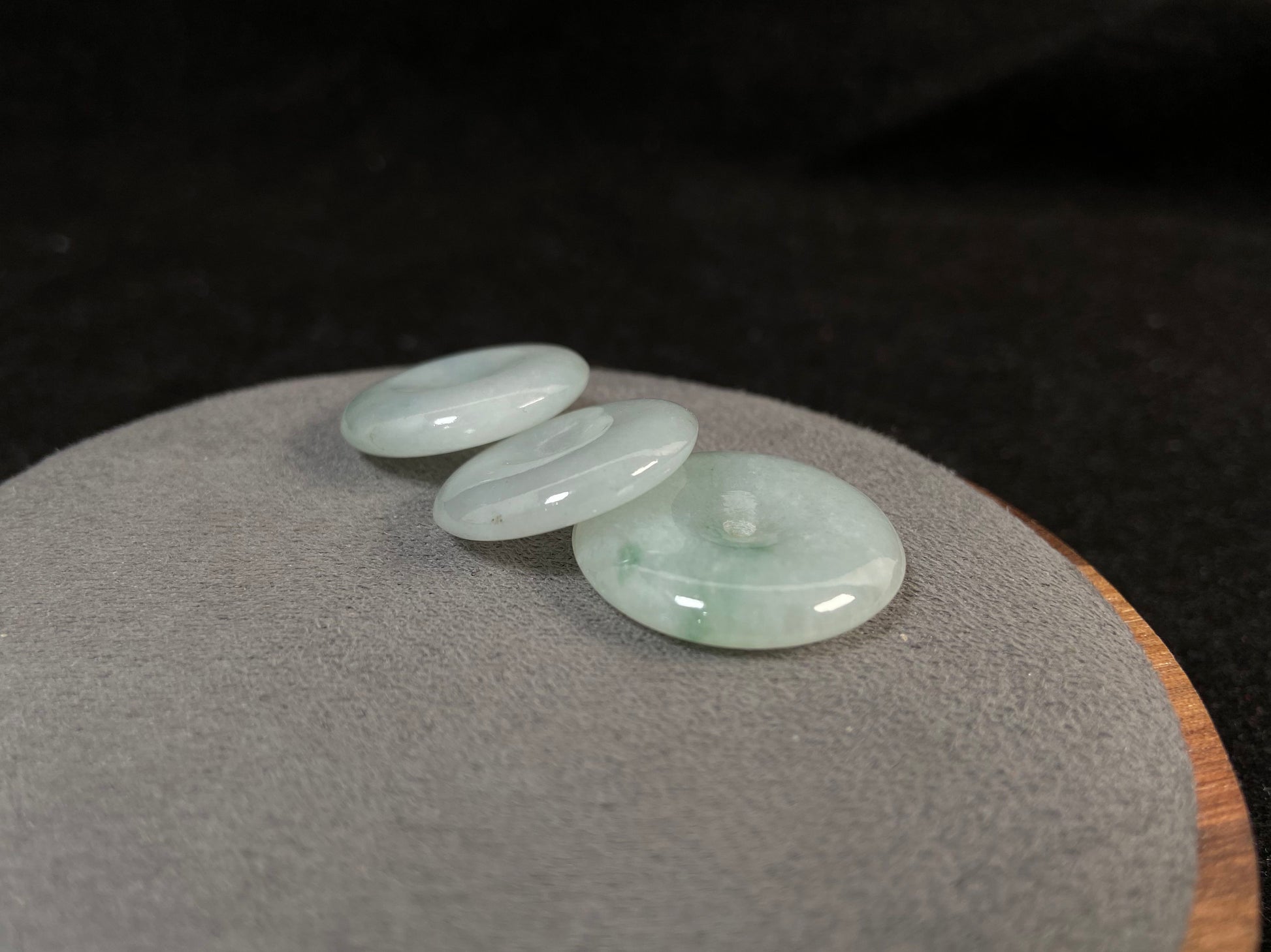 Translucent white jade cabochons featuring soft green patterns.