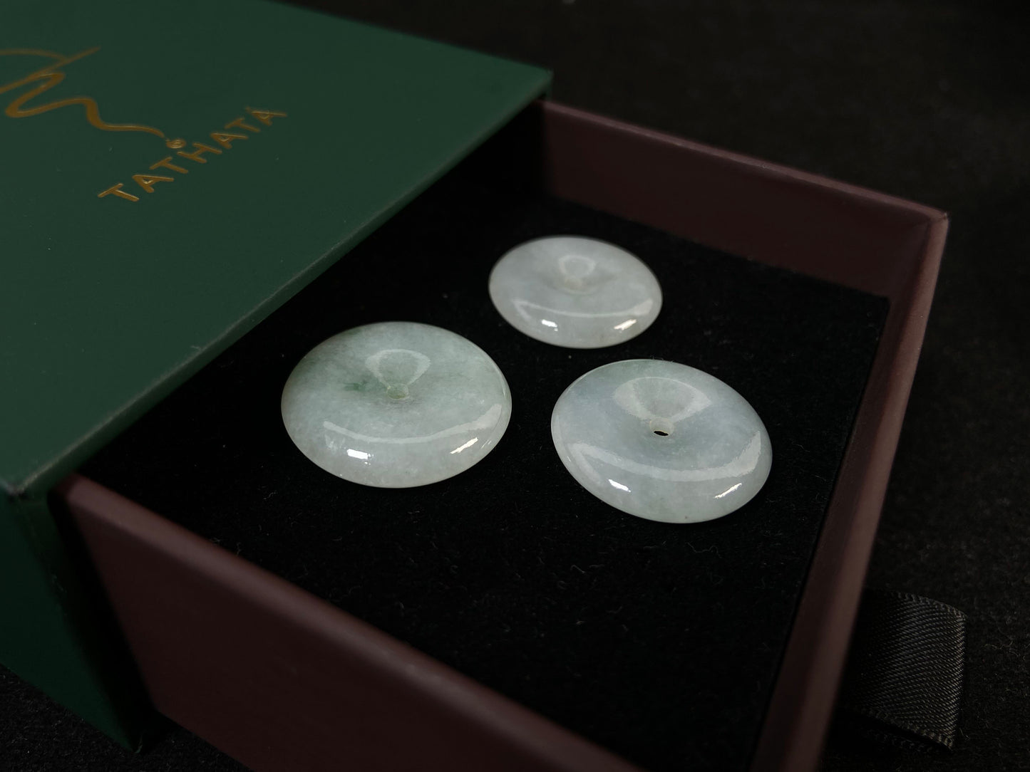 Translucent white jade cabochons featuring soft green patterns.