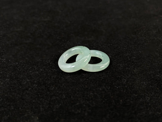 A clear light green jade hoop with black accents.