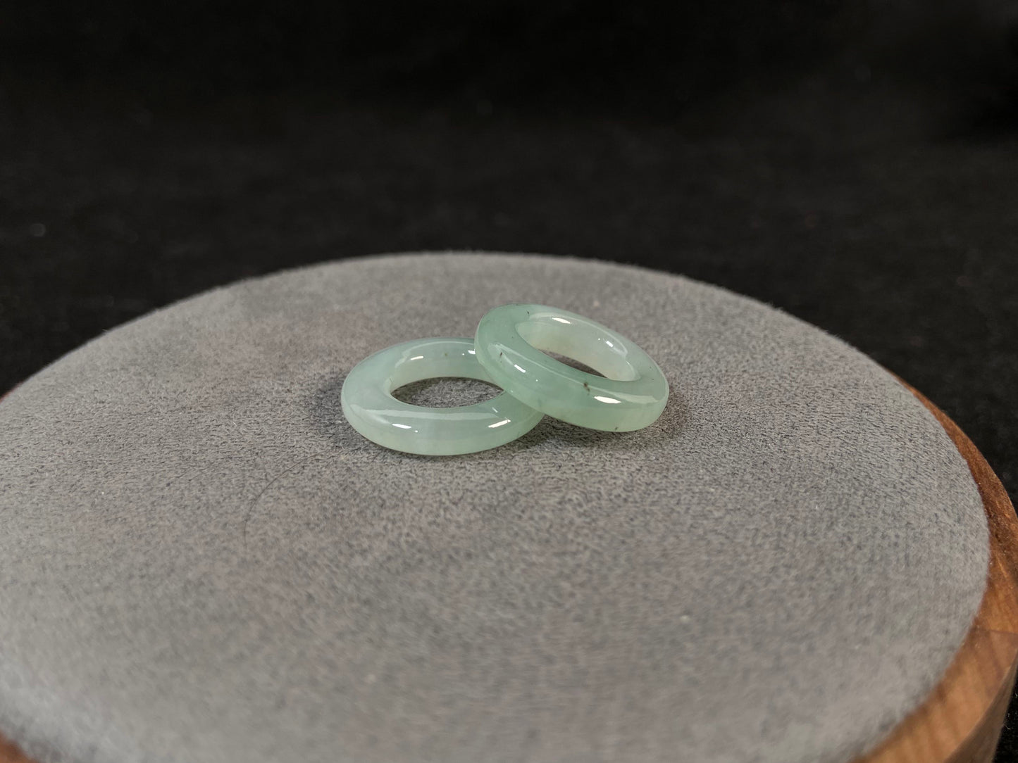 A clear light green jade hoop with black accents.