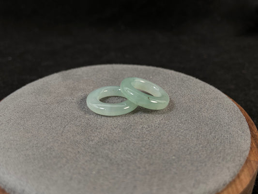 A clear light green jade hoop with black accents.