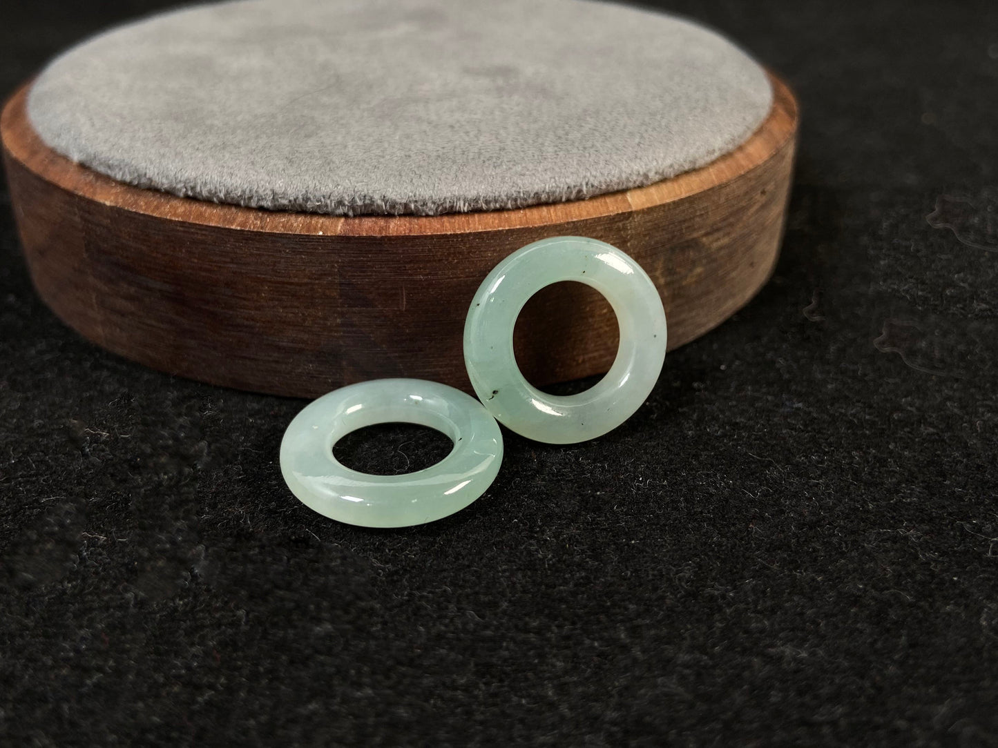 A clear light green jade hoop with black accents.