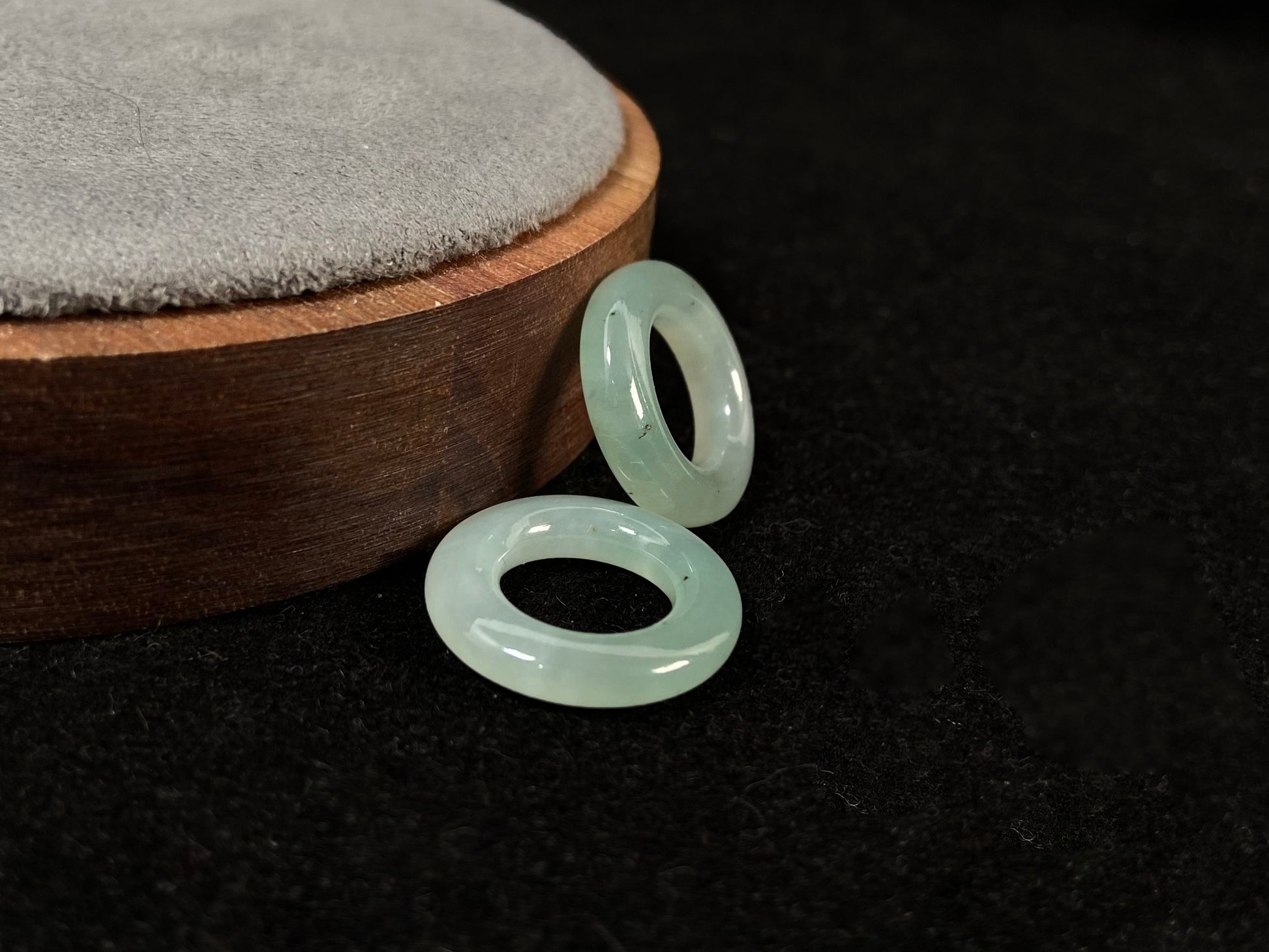 A clear light green jade hoop with black accents.