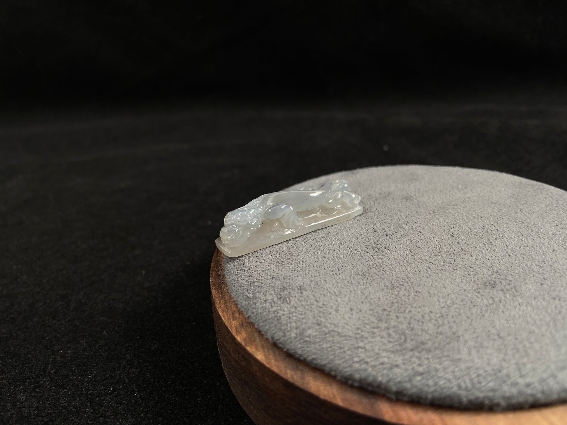 This jadeite is carved into a dragon motif in semi-transparent, milky white jade.