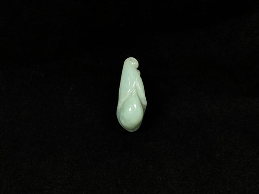 A light green jadeite magnolia bud carving.