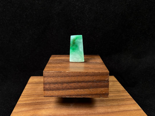 The jadeite wushi plaque presents a clean white base adorned with natural green veining.