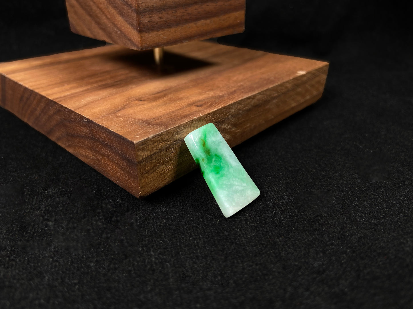 The jadeite wushi plaque presents a clean white base adorned with natural green veining.