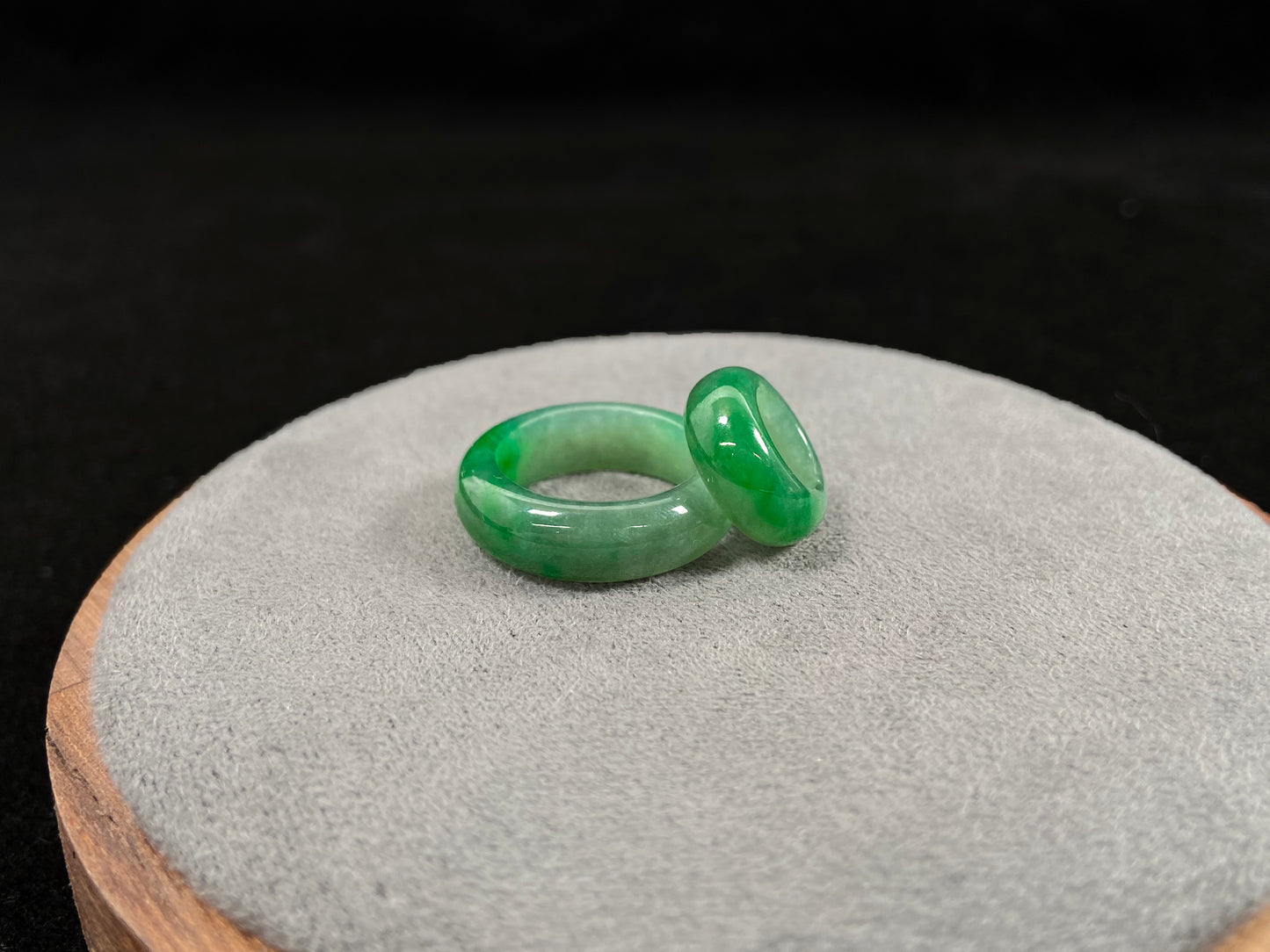 A loose jadeite with a light green base and vibrant green mother-child pendant accents.