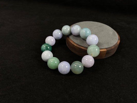 A beaded jadeite bracelet featuring purple, blue, light green, and dark green.