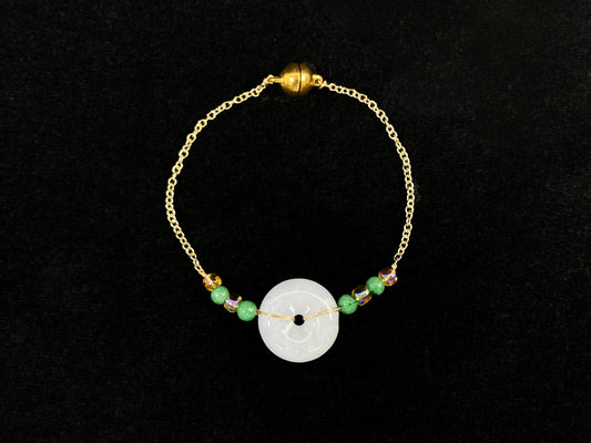 A milky white jadeite peace disc bracelet with alternating green beads and citrine crystals.