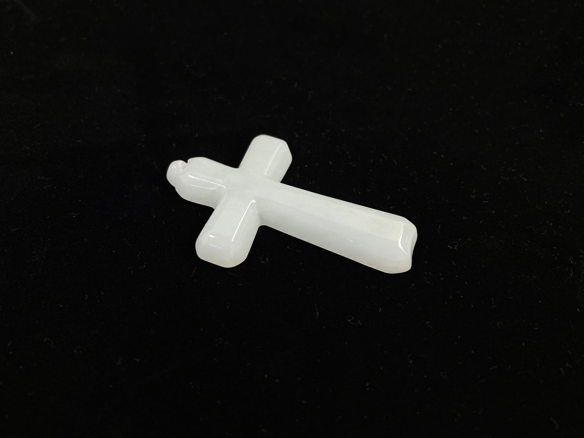 This is a creamy white jadeite cross.