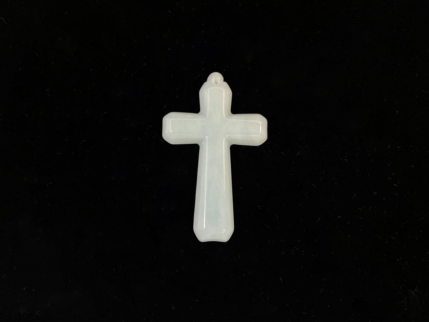 This is a creamy white jadeite cross.