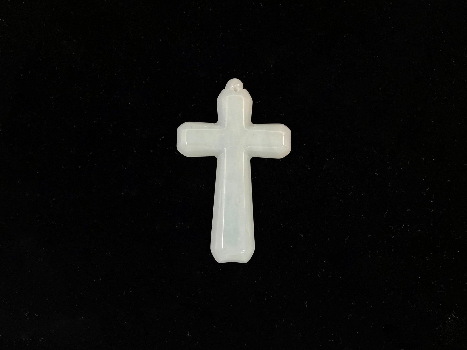 This is a creamy white jadeite cross.