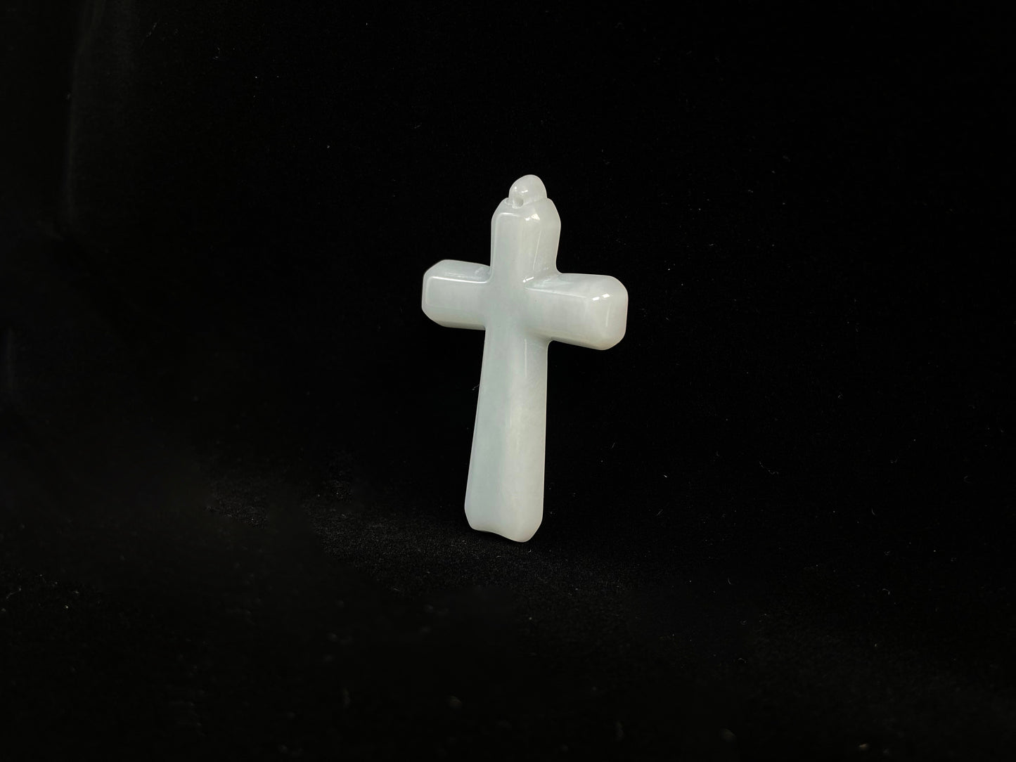 This is a creamy white jadeite cross.