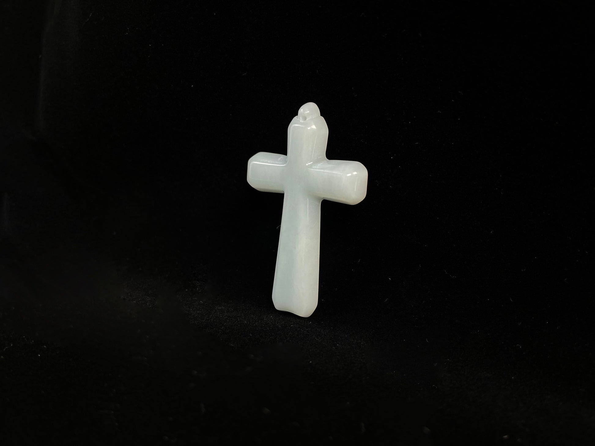 This is a creamy white jadeite cross.