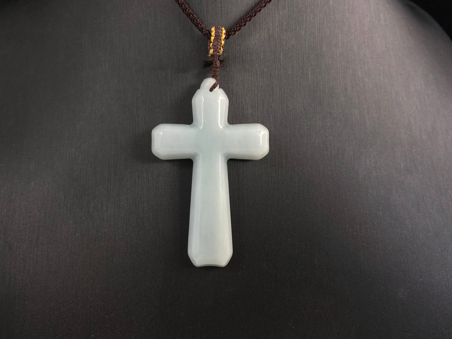 This is a creamy white jadeite cross.