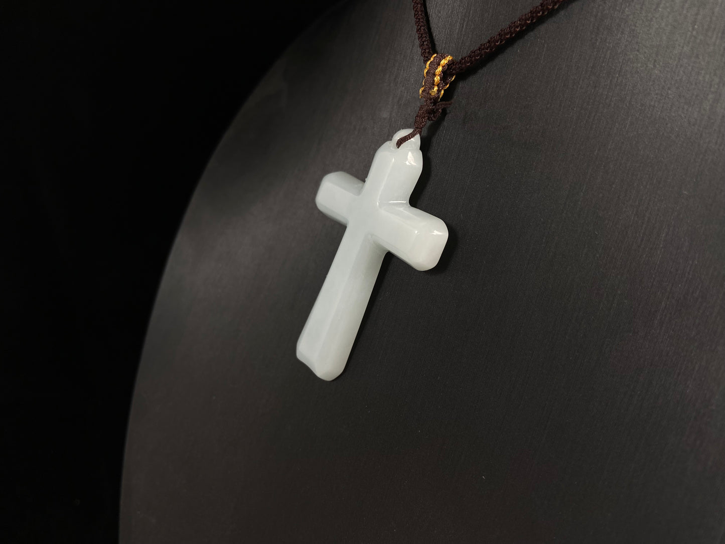 This is a creamy white jadeite cross.