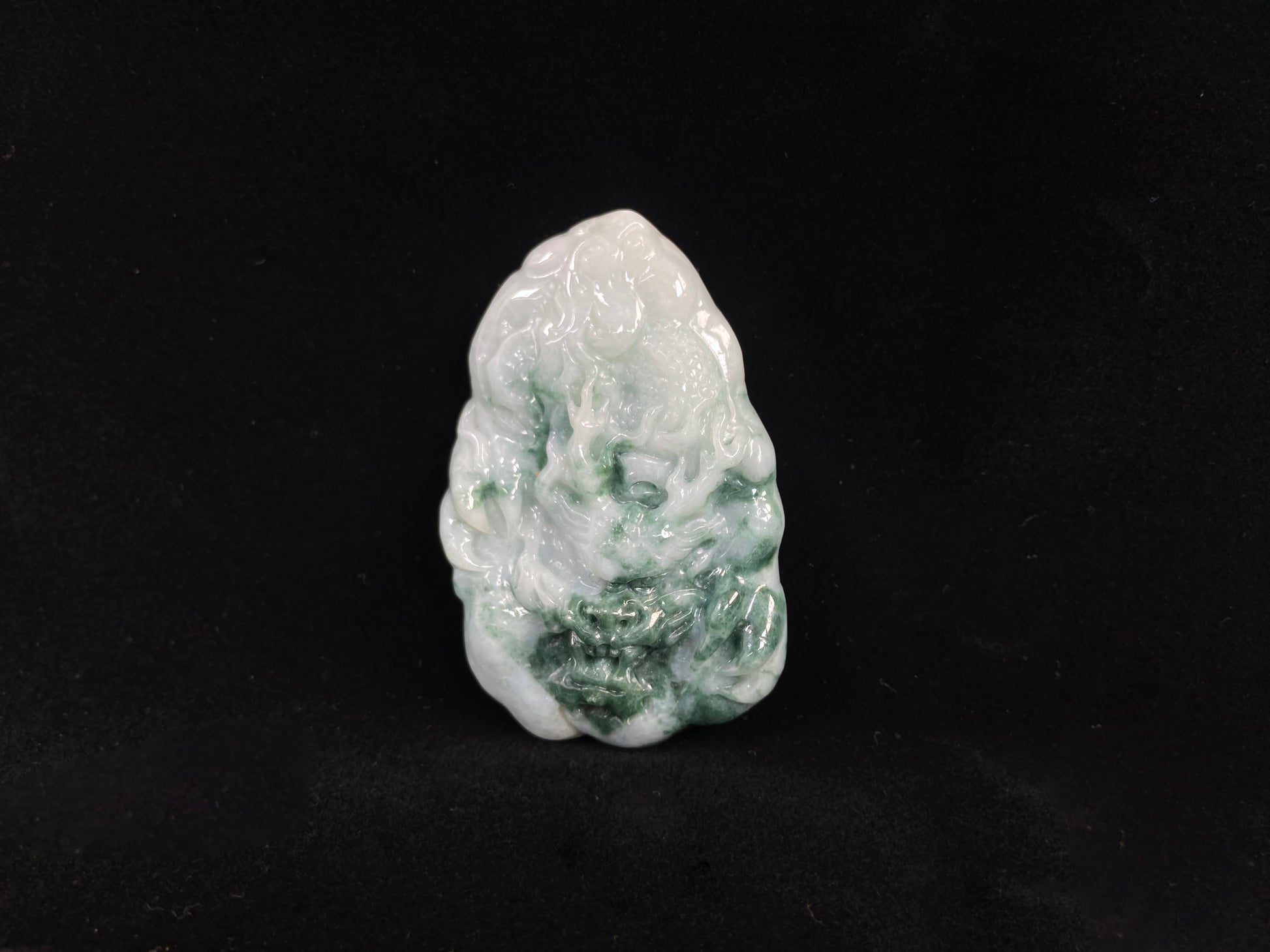 A milky white dragon with deep green accents.