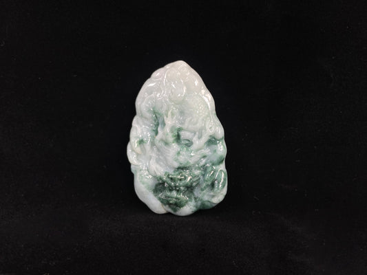 A milky white dragon with deep green accents.