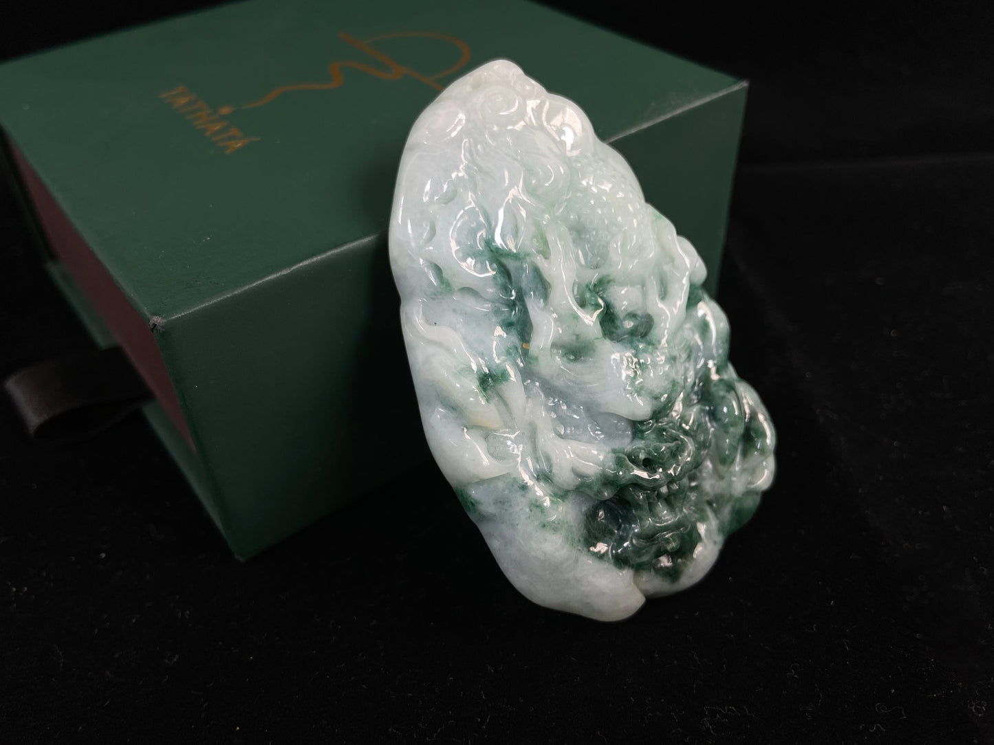 A milky white dragon with deep green accents.