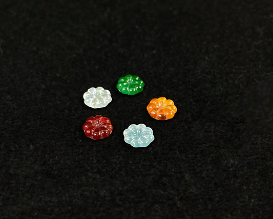 Five sunflowers carved from jade in white, green, yellow, red, and blue.